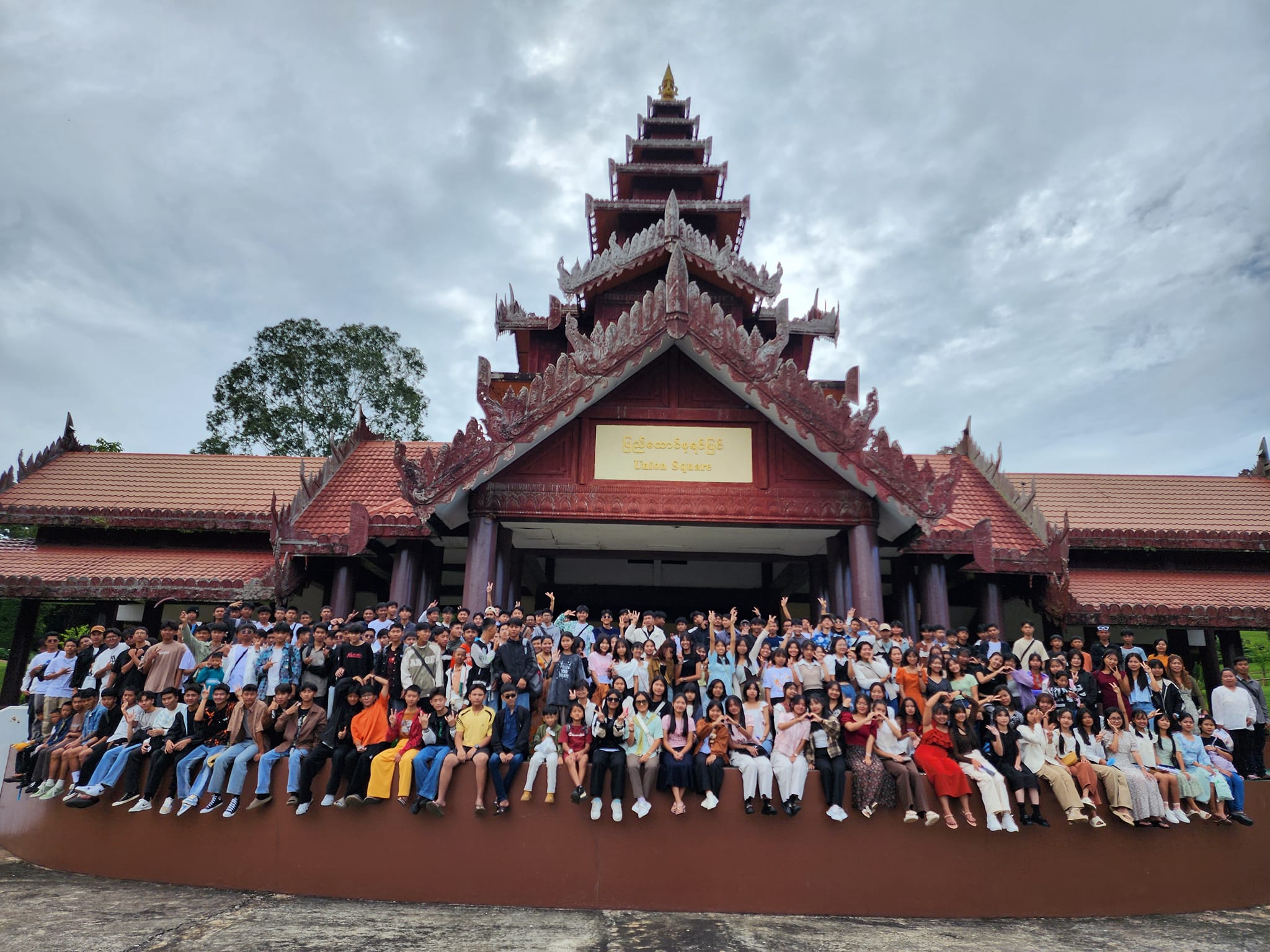 Students gathered outside a traditional building